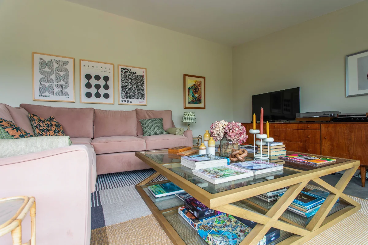 The Granary living room with pink sofa, record player and coffee table